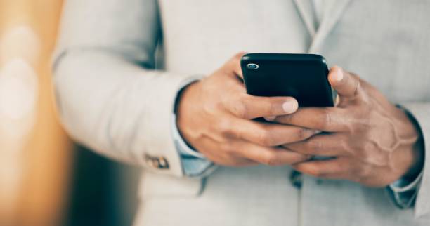 istock Shot of an unrecognizable businessperson using a phone at work 1382302991