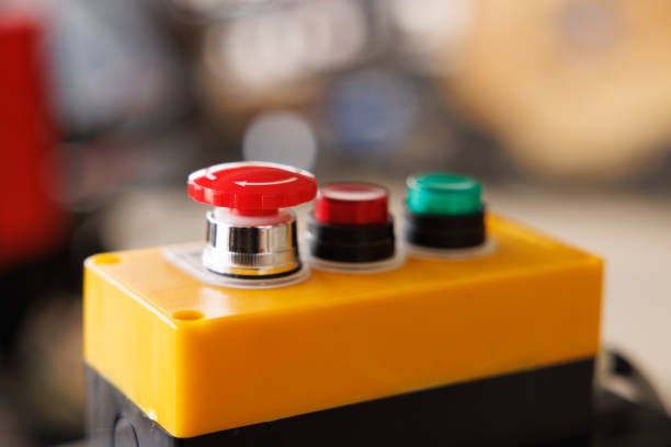 emergency stop button with blur background in industry factory. start stop button.