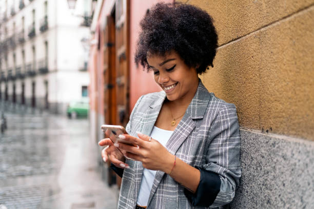 istock Pretty Afro Woman Using Phone 1382307929