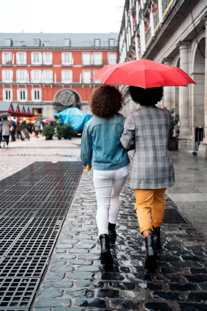 istock Back View Friends in Rainy Day 1382308488