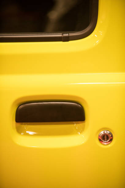 istock Modern door handle of a yellow car 1382311981