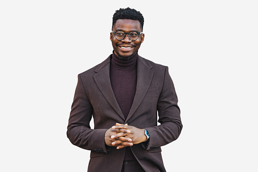 Young black cheerful businessman outdoors looking at camera with smile