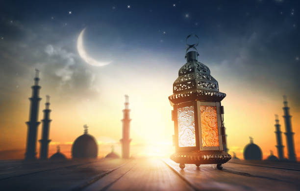 Ornamental Arabic lantern with burning candle Ornamental Arabic lantern with burning candle glowing at night. Festive greeting card, invitation for Muslim holy month Ramadan Kareem. eid lantern stock pictures, royalty-free photos & images