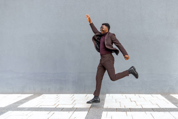 istock Energetic Young Man Businessman Jumping 1382319876