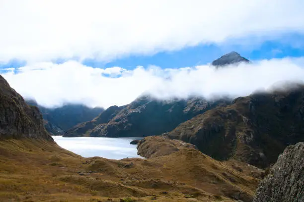 Photo of Cloud shrouded mountains and Lake Harris, Routeburn Track Harris Saddle,  New Zealand