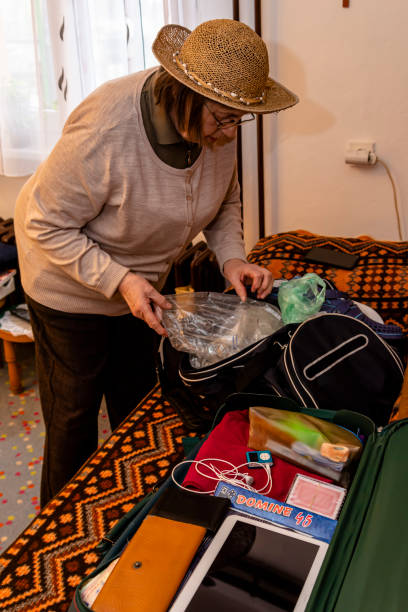 istock A senior woman packs things for a vacation trip 1382331921