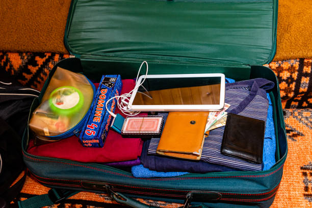 istock Open suitcase with clothes and personal things packed for travelling. 1382333429