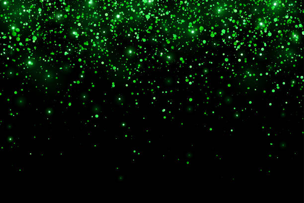 istock Green glitter shiny holiday confetti with glow lights on black background. Vector 1382343606