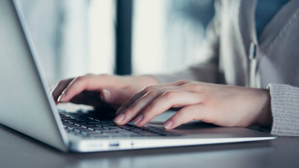 istock Woman hands on laptop keyboard 1382347554