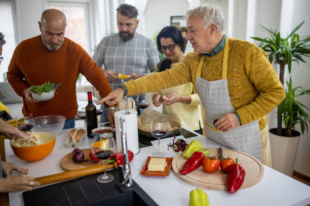 istock Party host making the meal for his friends in the kitchen 1382348402