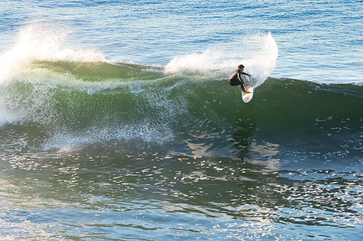 Pichilemu, Region de O'Higgins, Chile - January 13, 2022: Surfer at Punta de Lobos a surfing beach at the south of Pichilemu.