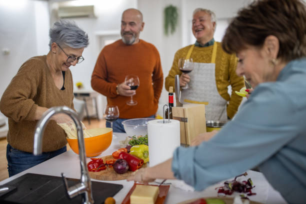istock Senior Caucasian friends having fun while making the lunch together 1382350743