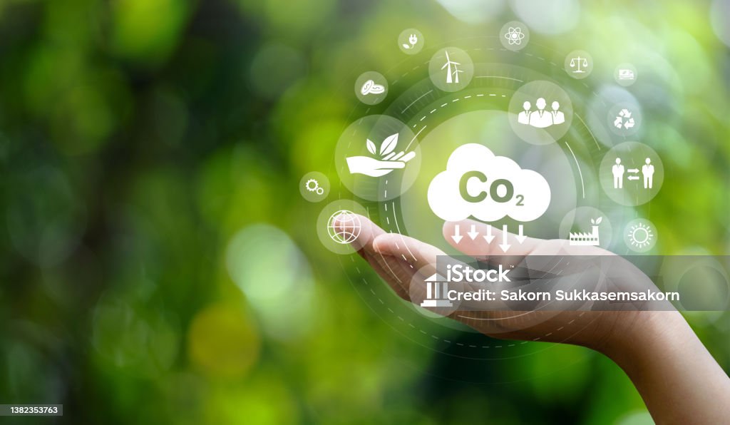 CO2 emission reduction concept in hand with environmental icons, global warming, sustainable development, connectivity and renewable energy green business background. Coal Stock Photo