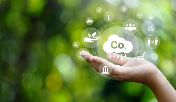 co2 emission reduction concept in hand with environmental icons, global warming, sustainable development, connectivity and renewable energy green business background. - concepts and ideas nature imagens e fotografias de stock