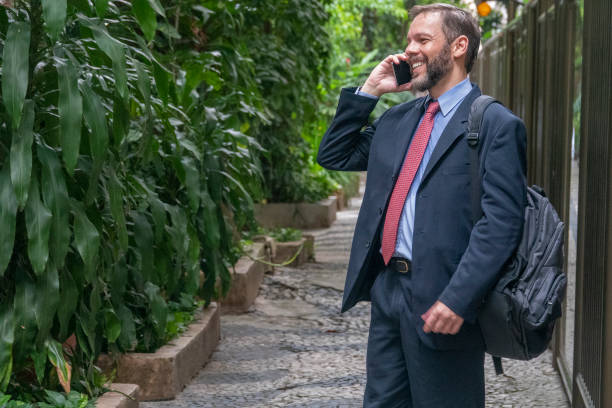 istock Business man smiles, satisfied with success at work 1382355598