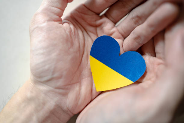 istock Ukraine flag color heart in hands 1382359218