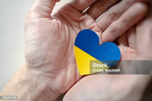 Ukraine Flag Color Heart In Hands Stock Photo - Download Image Now - Stand with Ukraine, Blue, Yellow