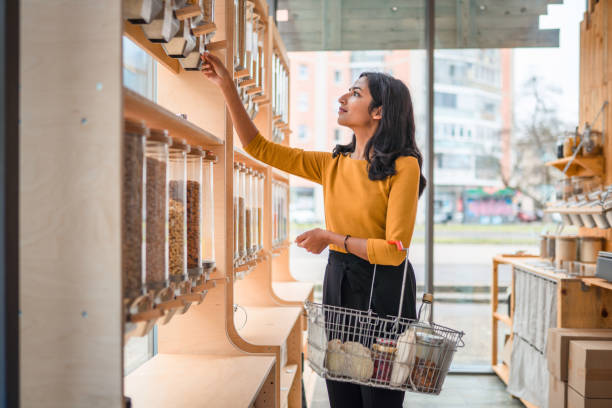 Young Adult Indian Female Shopping In A Sustainable Store stock photo