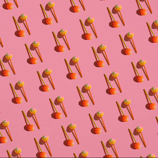 istock Colorful Set of Lollipops. pattern made with caramel on a stick on bright pink background.  creative pattern.  lot of lollipops chupa chups. 1382364873