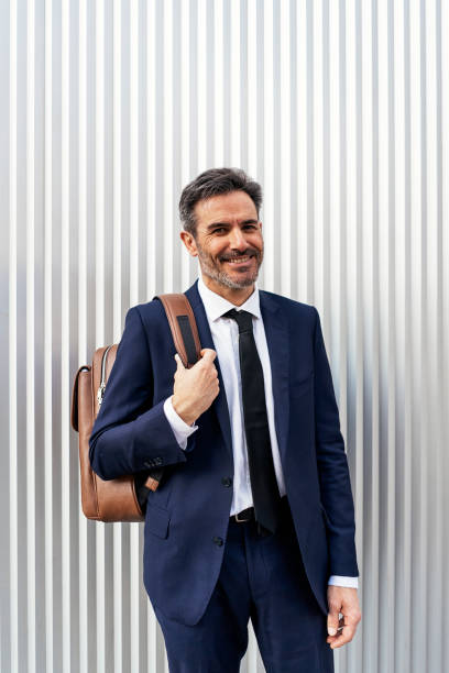 istock Mature businessman with backpack on street 1382370442