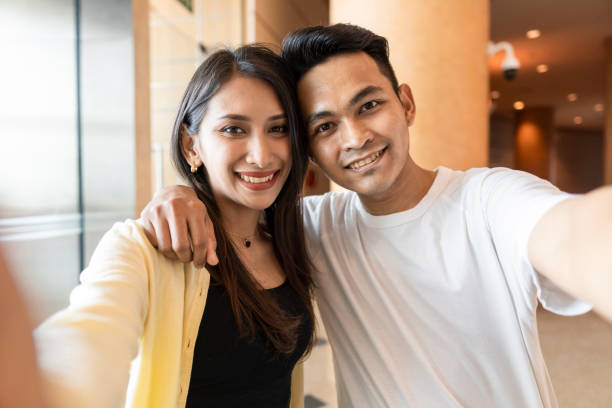 istock Young couple smiling to the camera 1382372672