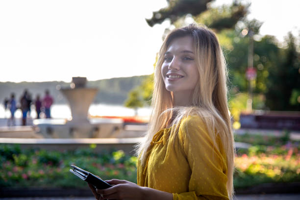 istock A beautiful young blonde is walking in the park. 1382372790