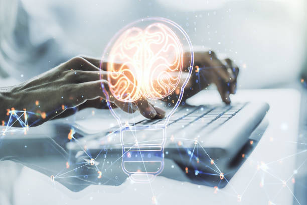 Creative idea concept with light bulb and human brain illustration and with hands typing on laptop on background. Neural networks and machine learning concept. Multiexposure stock photo