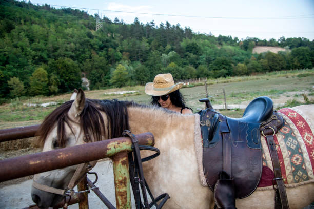 istock Attractive brunette and beautiful horse. 1382372799
