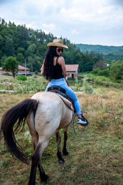 istock Attractive brunette and beautiful horse. 1382372807