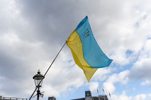 Ukrainian flag against the cloudy sky.