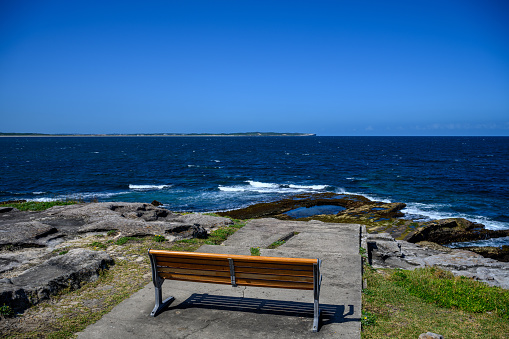 Park bench with a scenic view over the pacific Ocean