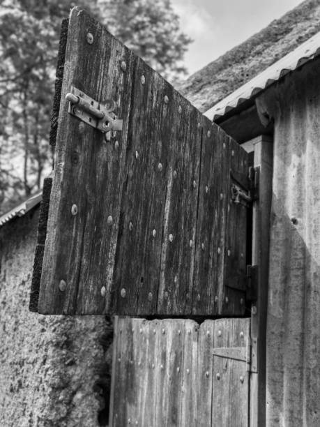 Opened door with nail effect outer on grained wood.