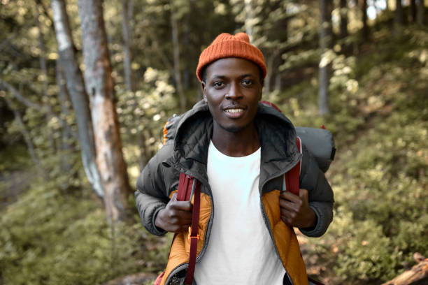 istock Latin guy wander among trees with backpack, young man enjoying time alone in forest. Escape from hectic life to wildlife. Camping, hiking, travelling, search for adventures concept 1382376229