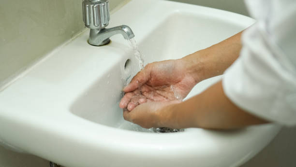 istock washing hands in the white sink to keep his hand clean and sterile 1382377882