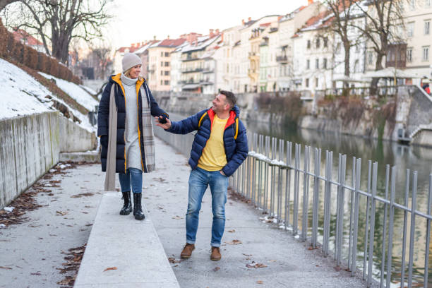 istock Happy couple walking by the river 1382378004