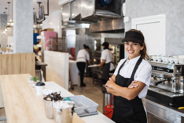 istock Beautiful young woman working on coffee maker machine 1382378226