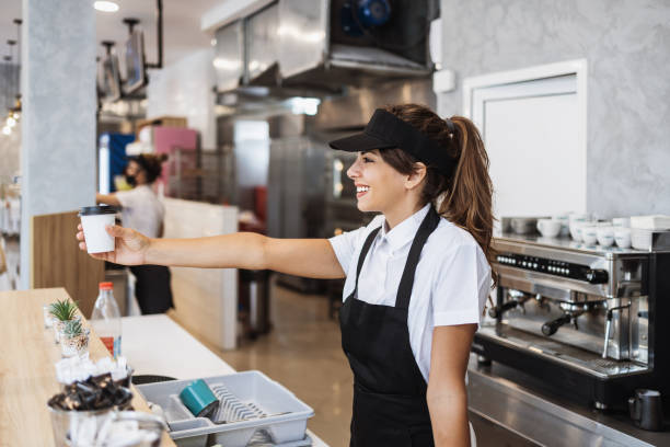 istock Beautiful young woman working on coffee maker machine 1382378253