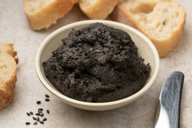 istock Bowl with fresh made black hummus close up 1382379981