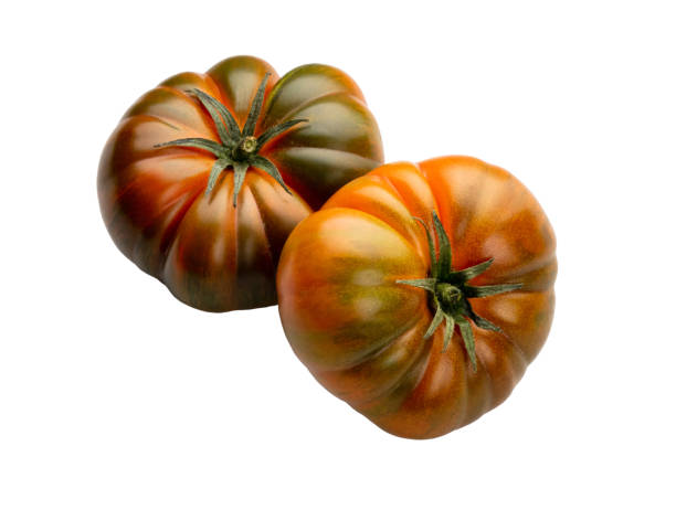 istock Heirloom tomato isolated on white background. Tomato clipping path. 1382380528