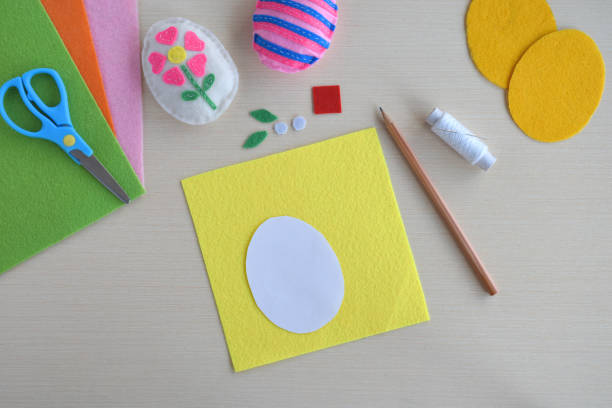 istock Making handmade easter eggs from felt with your own hands. Childrens DIY concept. Easter decoration 1382381095