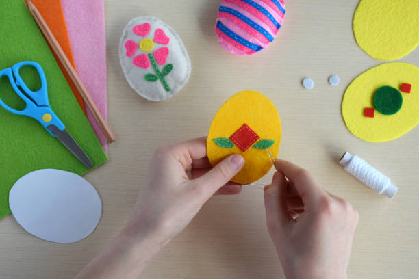 istock Making handmade easter eggs from felt with your own hands. Childrens DIY concept. Easter decoration 1382381104