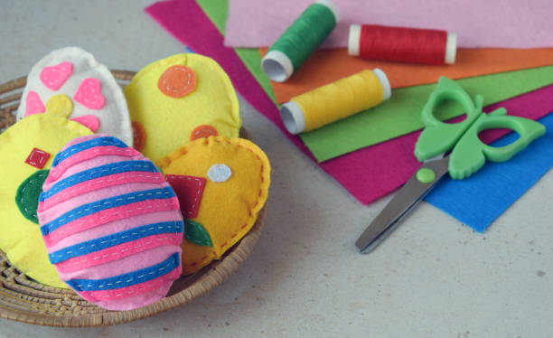 istock Making handmade easter eggs from felt with your own hands. Childrens DIY concept. Easter decoration 1382381708