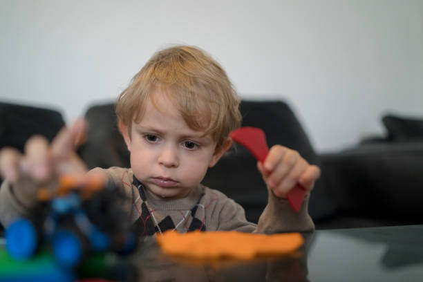 Almost 2 years old child playing plasticine in children's room