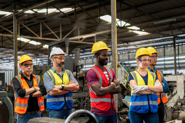 istock Workers and workers are standing in the factory. Group Staff Standing In Engineering Factory. 1382382946