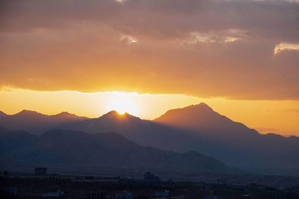 Sun sets between the mountains surround the city of Kabul