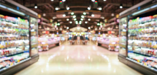 supermarket grocery store aisle and shelves blurred background stock photo