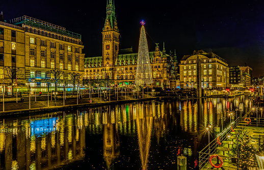 illuminated Christmas tree and lighted town hall with Binnenalster in the foreground - Hamburg