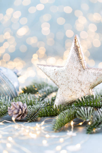 istock Christmas spruce with star and blurred shiny lights. 1382387417