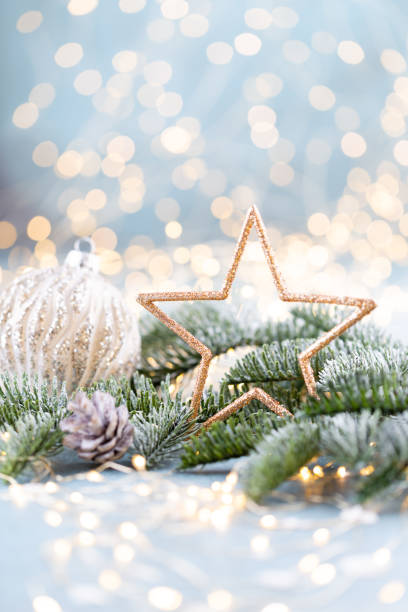 istock Christmas spruce with star and blurred shiny lights. 1382388623