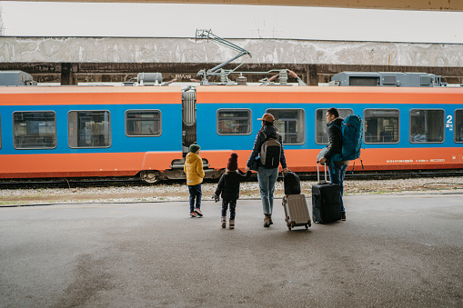Family with two children at the train station